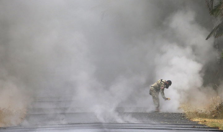 U.S. Army National Guard 1st Lt. Aaron Hew Len takes measurements for sulfur dioxide gas at volcanic fissures in Leilani Estates on Tuesday.