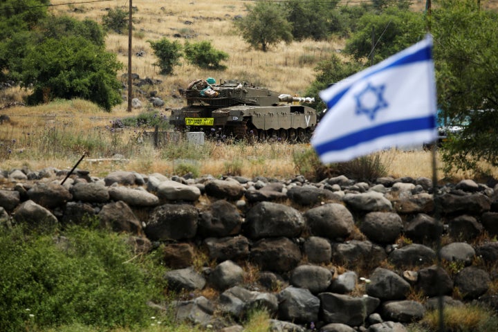 An Israeli tank can be seen near the Israeli side of the border with Syria in the Israeli-occupied Golan Heights, Israel May