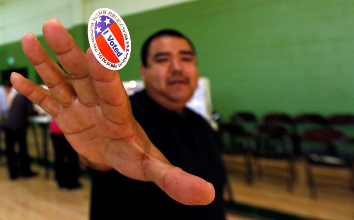 Anthony Partida shows his sticker after voting at the Evergreen Recreation Center on Election Day.