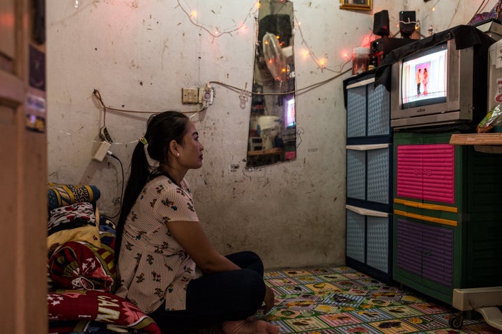 After work, Istiy watches TV in her tiny rental home.