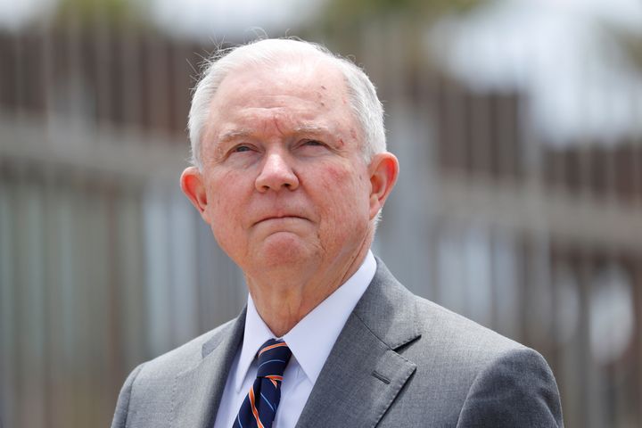 Attorney General Jeff Sessions stands next to the border fence near San Diego on May 7 as he discusses immigration enforcement.