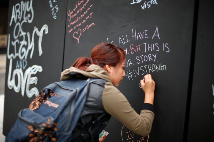 A student signs on a remembrance wall in the Isla Vista neighborhood of Santa Barbara, California May 27, 2014. Twenty-two year old Elliot Rodger killed six people before taking his own life in a rampage through a California college town shortly after he posted a threatening video railing against women.