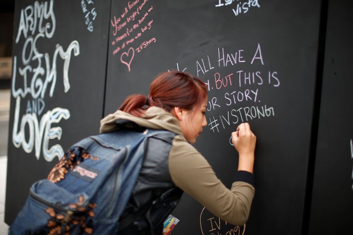 A student signs on a remembrance wall in the Isla Vista neighborhood of Santa Barbara, California May 27, 2014. Twenty-two year old Elliot Rodger killed six people before taking his own life in a rampage through a California college town shortly after he posted a threatening video railing against women. 