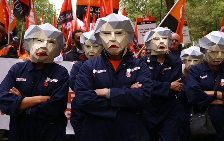 <strong>People dressed as Theresa May Bots during a TUC rally in central London, as part of its 'great jobs' campaign.</strong>