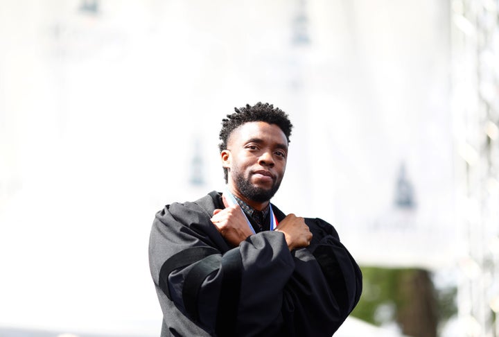 Boseman makes the "Wakanda Forever" sign during Howard University's commencement ceremony.