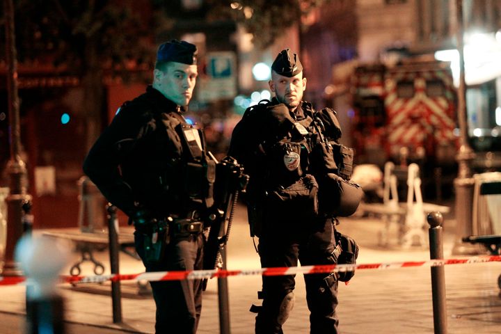 Policemen stand guard in a street of Paris centre after one person was killed and several injured by a man armed with a knife.