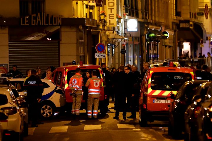 Paris' Mayor Anne Hidalgo (C) talks to emergency service members in a street in Paris centre.