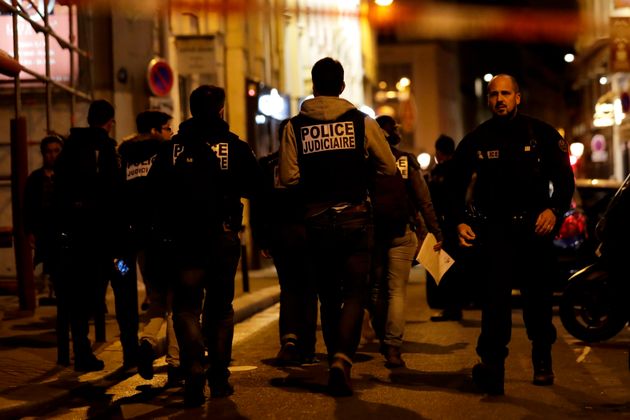 Policemen walk in a street in Paris centre after one person was killed and several injured by a man armed with a knife.