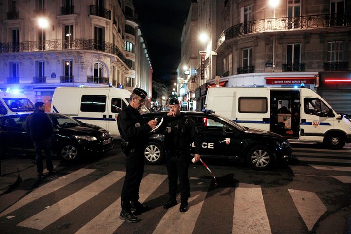 Policemen stand guard in a street of Paris centre.