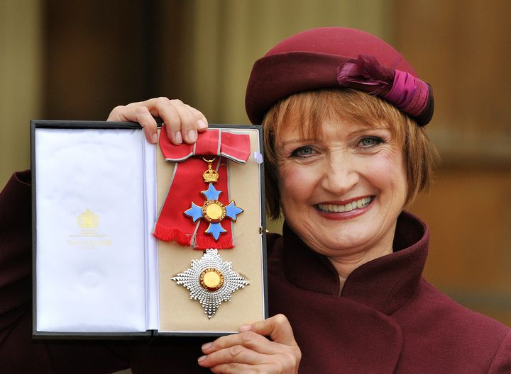  Dame Tessa proudly holding her Dame Commander insignia in 2013