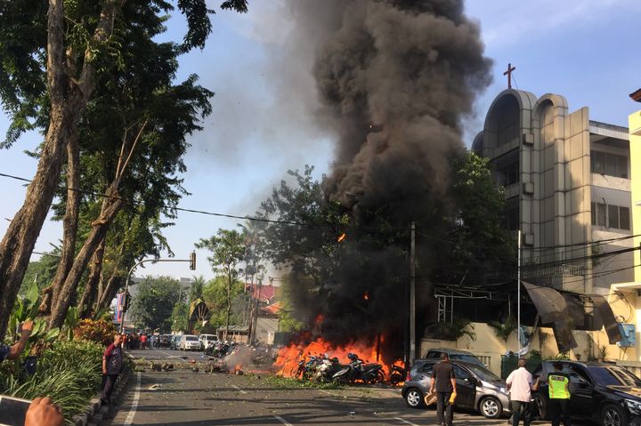 Motorcycles burn following a blast at the Pentecost Church Central Surabaya (GPPS), in Surabaya, East Java, Indonesia May 13, 2018.