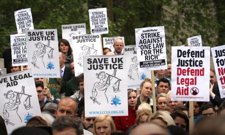 People protesting against proposed changes to legal aid outside of the Houses of Parliament 