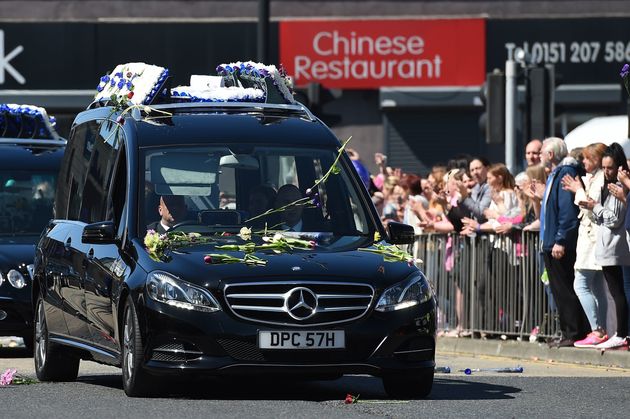 Crowds clapped and threw flowers as the funeral cortege drove past 