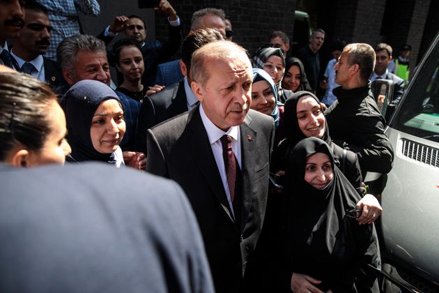 Turkish President Recep Tayyip Erdogan poses for a photograph with supporters after speaking at Chatham House on May 14