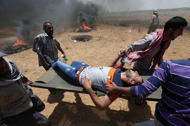A wounded Palestinian is evacuated during the protest.