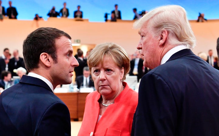 French President Emmanuel Macron, German Chancellor Angela Merkel and U.S. President Donald Trump confer at the start of the first working session of the G-20 meeting in Hamburg, Germany, on July 7, 2017.