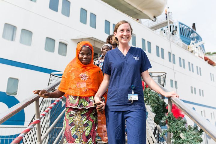 Mariamou after her surgery with volunteer nurse Lucy Hedges, leaving the ship.