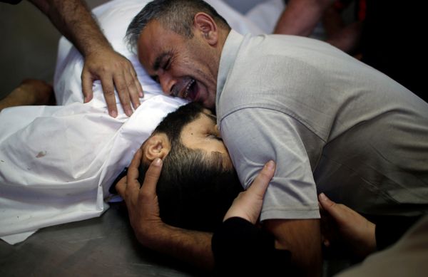 The brother of Palestinian Shaher al-Madhoon, who was killed during a protest at the Israel-Gaza border, reacts over his body