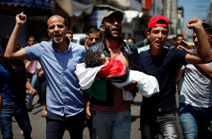 Mourners carry the body of 8-month-old Palestinian infant Laila al-Ghandour, who died after inhaling tear gas during a protest against U.S embassy move to Jerusalem at the Israel-Gaza border, during her funeral in Gaza City, May 15, 2018. 