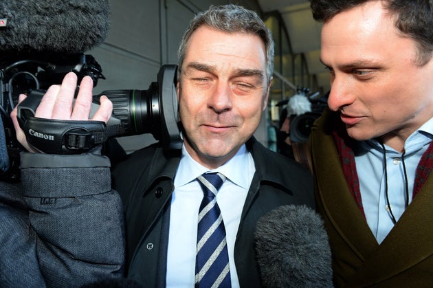 Richard Howson, former Chief Executive, reacts as a TV camera is pressed into his face leaves, as he leaves Portcullis House in London after answering MPs' questions. 