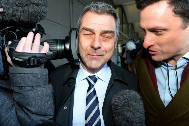 Richard Howson, former Chief Executive, reacts as a TV camera is pressed into his face leaves, as he leaves Portcullis House in London after answering MPs' questions. 