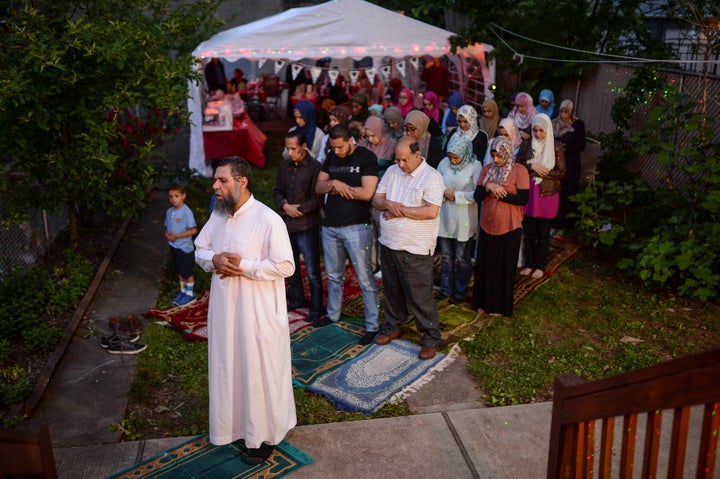 An imam leads a Maghrib sunset prayer during Ramadan for a family in Bayonne, New Jersey, on June 2, 2017. 