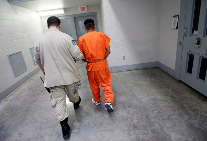 A Val Verde Correctional Facility officer moves an inmate from solitary confinement. A stint in solitary at some prisons can be prompted by as little as smoking in an unauthorized area.