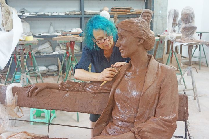 The sculptor, Laury Dizengremel, at work on the statue