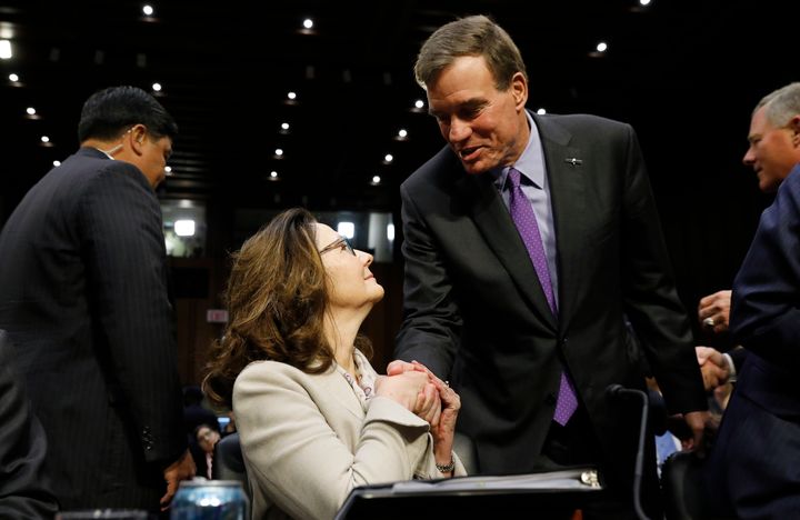 CIA director nominee Gina Haspel is greeted by Sen. Mark Warner before her confirmation hearing on May 9, 2018.