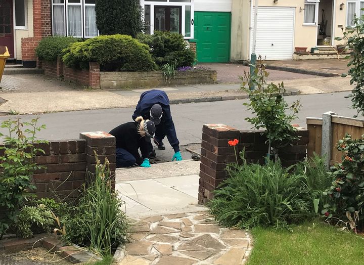 Police officxers searching drains in Ashmour Gardens, Romford, where an 85-year-old woman was found dead at her home by a handyman.