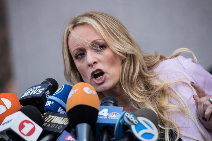 Porn actress Stormy Daniels, who claims she was paid off not to reveal an affair she had with Donald Trump, speaks to reporters in April.