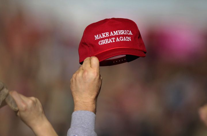 A supporter holds up a "Make America Great Again" hat during the April 28 rally.
