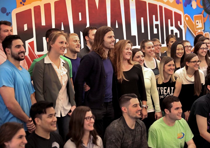 PharmaLogics employees pose with their CEO Megan Driscoll (center right) and Dan Price (center left), who influenced Megan's decision to increase her workers' salaries.