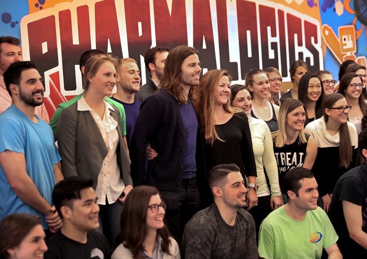 PharmaLogics employees pose with their CEO Megan Driscoll (center right) and Dan Price (center left), who influenced Megan's decision to increase her workers' salaries. 