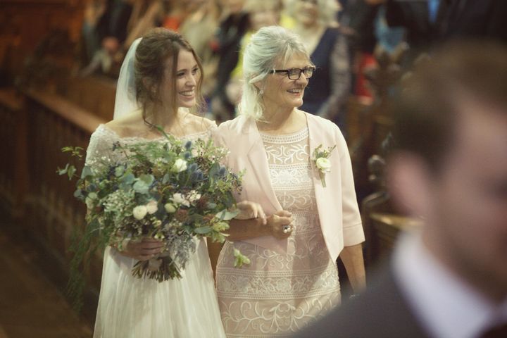 Stephanie Finch walking down the aisle with her mum.