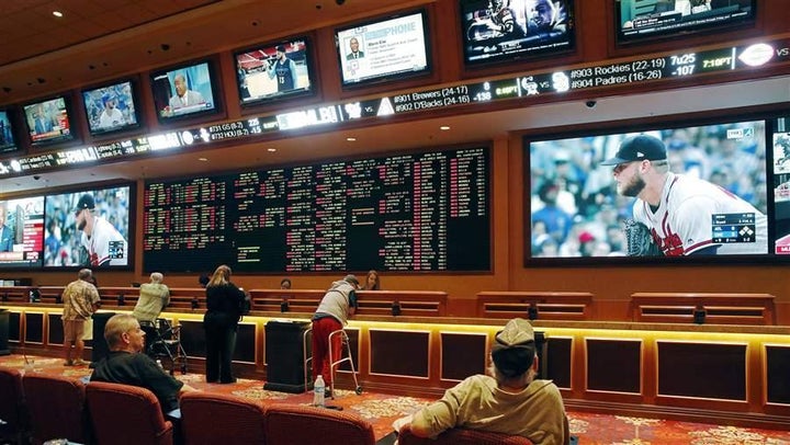 People make bets in the sports book at the South Point hotel and casino in Las Vegas. The U.S. Supreme Court has cleared the way for states to legalize sports betting, but many states spend little or no money to combat gambling addiction. 