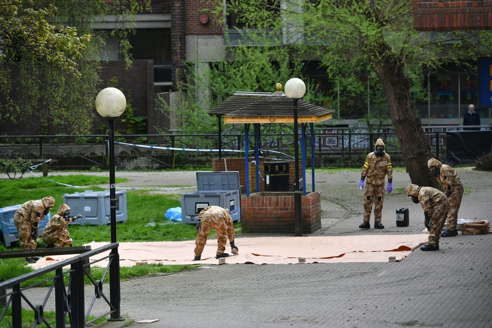 Military personnel lay a tarpaulin at the site near the Maltings in Salisbury where Russian double agent Sergei Skripal and his daughter Yulia were found on a park bench.