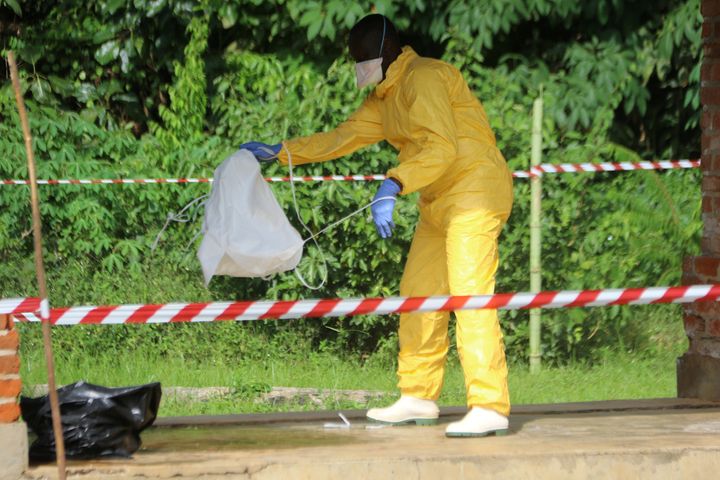 A health worker takes off protective clothing after visiting the isolation ward at Bikoro hospital