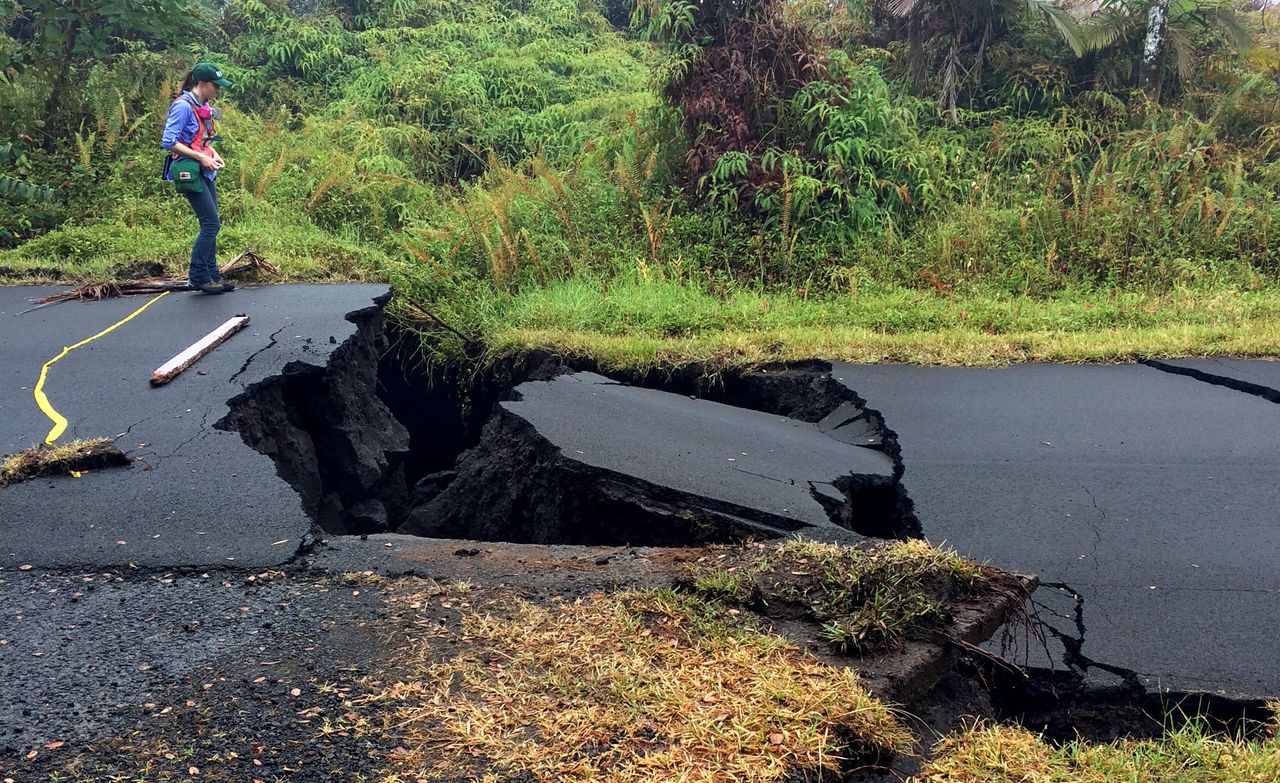 A geologist inspects cracks on a road in Leilani Estates, following eruption of Kilauea volcano, Hawaii May 17.