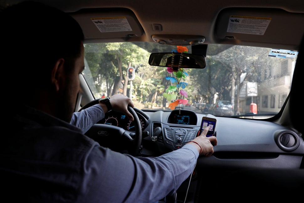 An Uber driver checks the Uber app inside his car in Mexico City, Mexico.&nbsp;