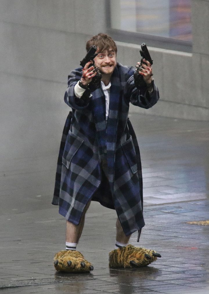 Daniel Radcliffe looking menacing while shooting guns and wearing tiger feet onset of "Guns Akimbo" in Auckland, New Zealand on May 6.