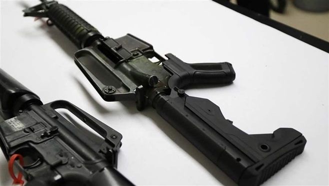 <p>A semi-automatic rifle at right that has been fitted with a bump stock device to make it fire faster. Laws to ban these devices have passed in seven states.</p>