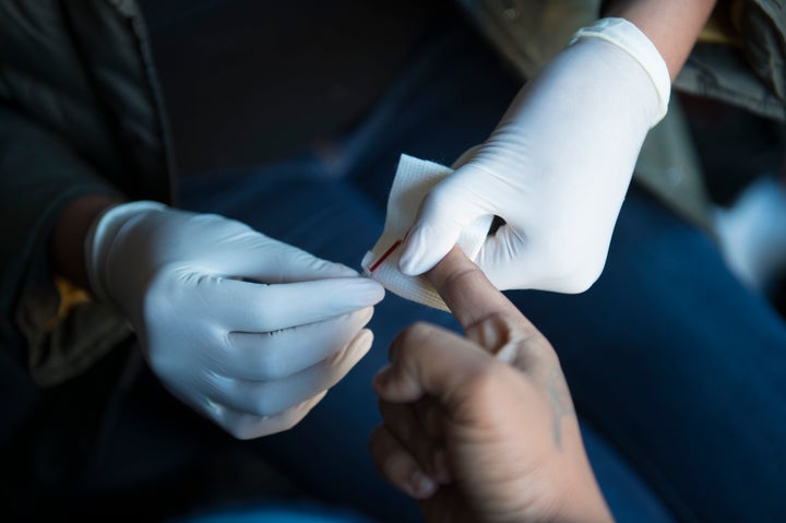 Symone Ferrell, 36, has her blood drawn for an HIV test administered by Cali Edmonds with the Women's Collective, near Benning Road Metro in Washington, D.C., on Dec. 20, 2016.