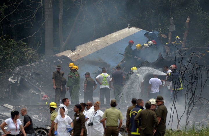 Emergency personnel work at the site of a plane crash outside Havana’s Jose Marti International Airport on Friday. 