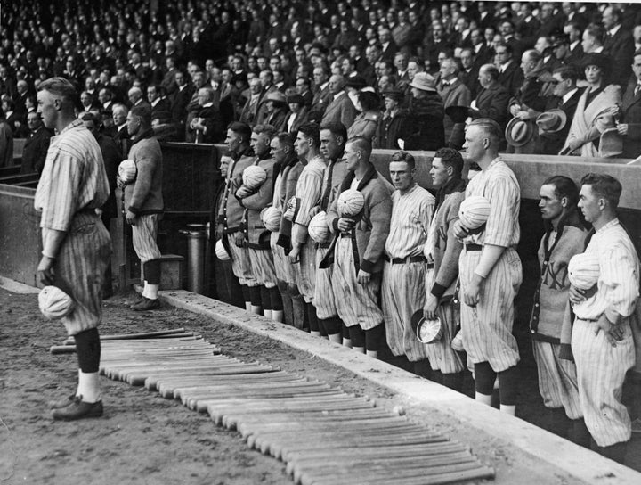 A man salutes during the national anthem before a baseball game