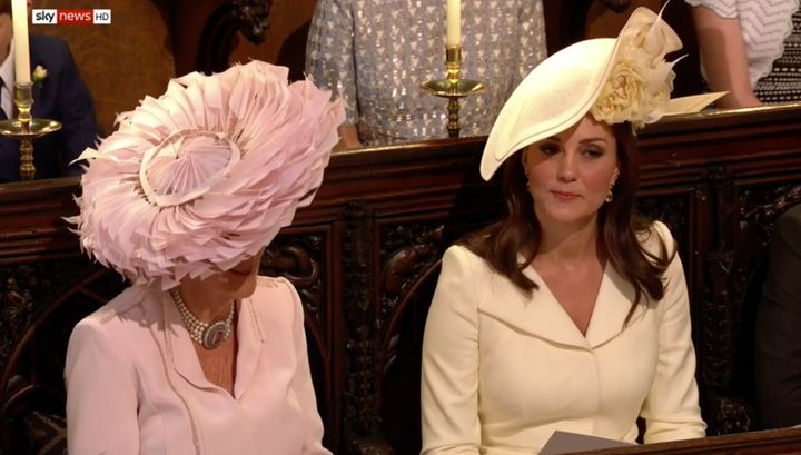 The Duchess of Cambridge (right) appears to suppress a little laugh while sitting next to the Duchess of Cornwall.