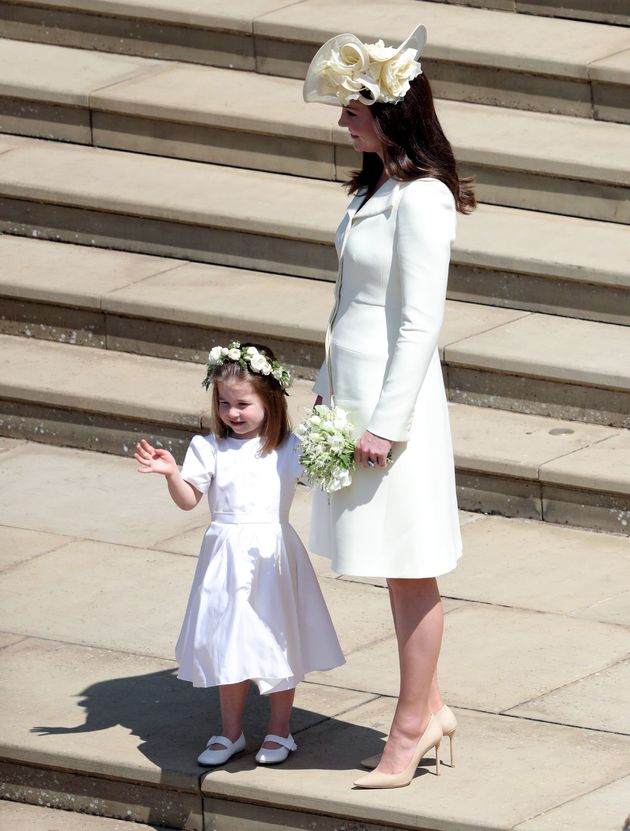 Princess Charlotte holding the hand of her mother, the Duchess of Cambridge.