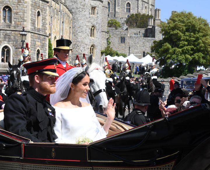 Prince Harry, Duke of Sussex and Meghan, Duchess of Sussex ride in the Ascot Landau open carriage during the procession following their marriage at St George's Chapel in Windsor Castle on May 19, 2018