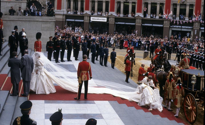 Diana, Princess of Wales, wearing an Emanuel wedding dress, enters St. Paul's Cathedral on the hand of her father, Earl Spencer, for her marriage to Charles, Prince of Wales in July 1981. 