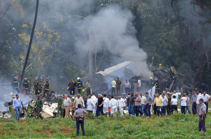 Cuban President Miguel Diaz-Canel (L, in khaki) is pictured at the site of the accident after a Cubana de Aviacion aircraft crashed after taking off from Havana's Jose Marti airport on May 18, 2018.